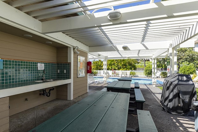 view of patio / terrace with a fenced in pool and a pergola