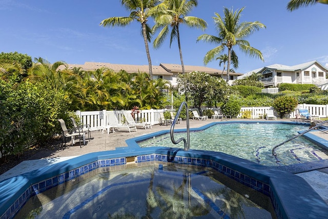 view of swimming pool featuring a patio and a hot tub