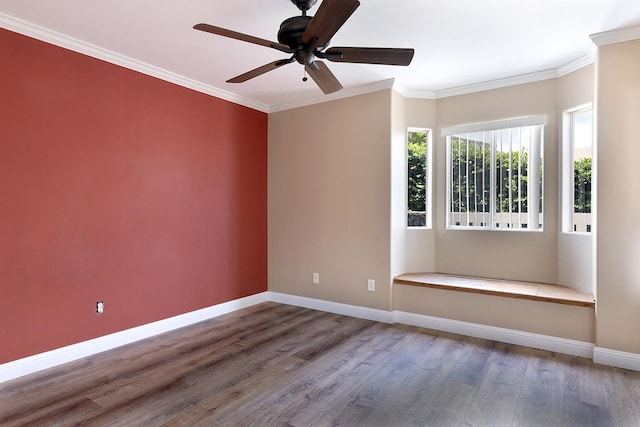 empty room with crown molding, ceiling fan, and hardwood / wood-style flooring