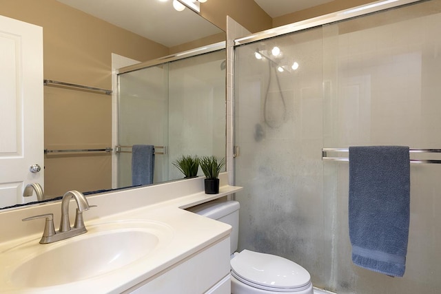 bathroom featuring vanity, toilet, and walk in shower