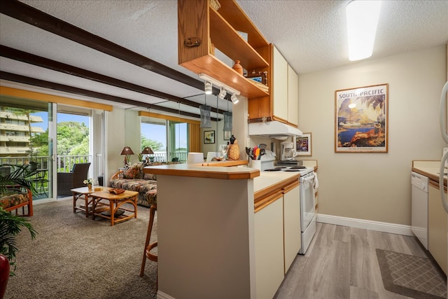 kitchen featuring a textured ceiling, light hardwood / wood-style flooring, beamed ceiling, white appliances, and kitchen peninsula