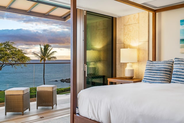 bedroom featuring a wall of windows and a water view