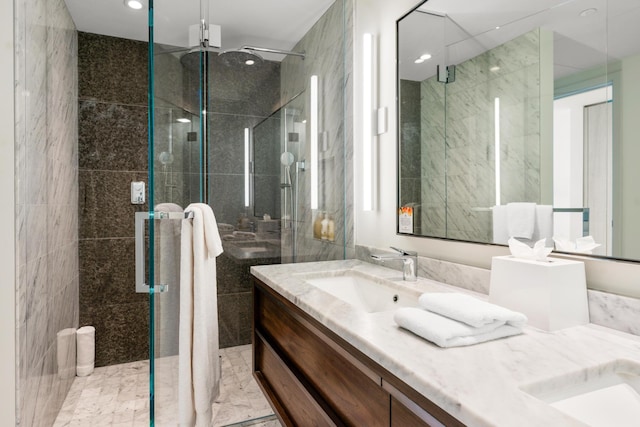 bathroom with vanity and a shower with shower door