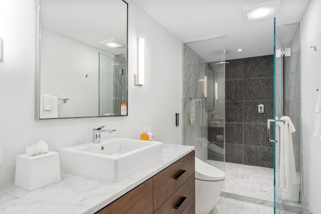 bathroom featuring vanity, an enclosed shower, and toilet