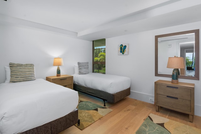 bedroom featuring multiple windows and light wood-type flooring