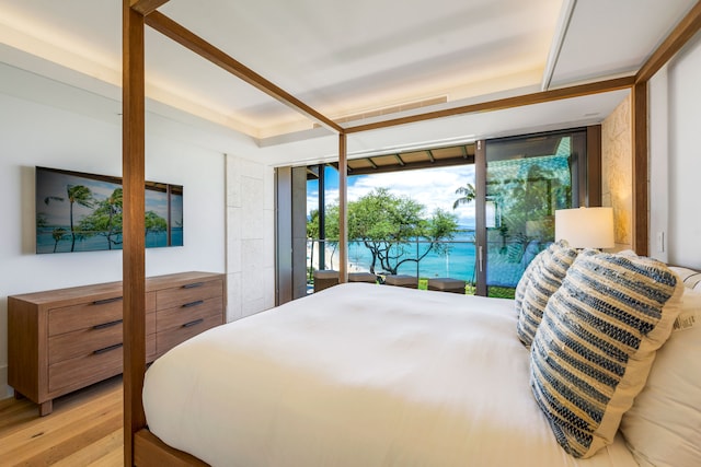 bedroom featuring access to exterior and light wood-type flooring