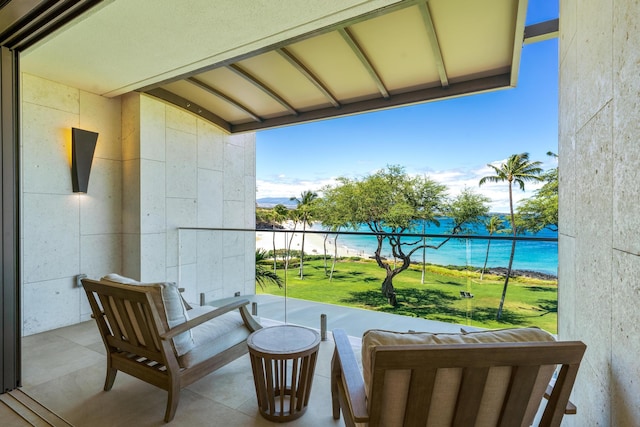 balcony with a water view and a beach view