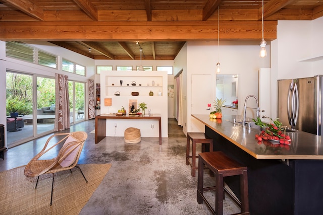 kitchen featuring decorative light fixtures, beamed ceiling, stainless steel fridge, and wood ceiling