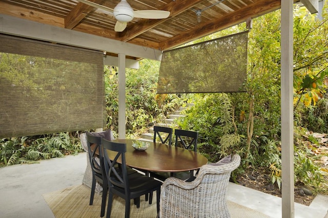 view of patio / terrace featuring a ceiling fan, outdoor dining area, and stairway