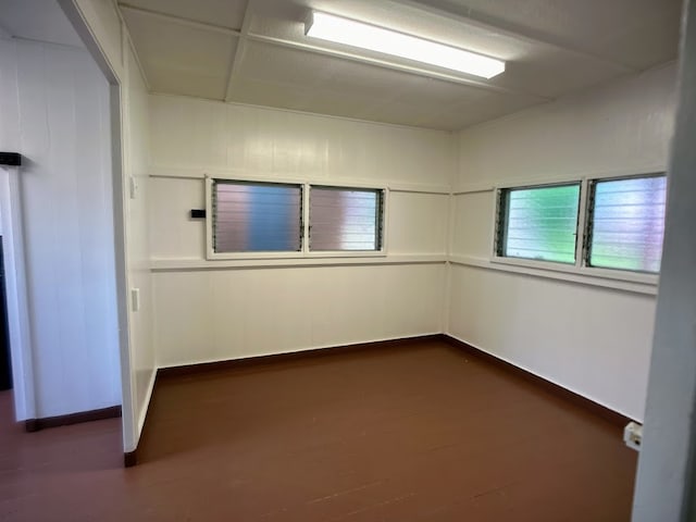 spare room featuring dark wood-type flooring