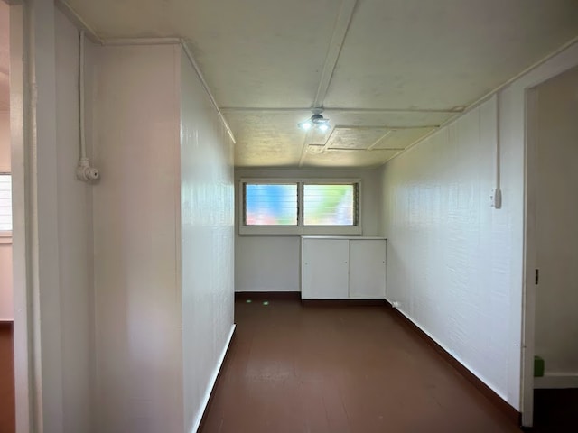 corridor with dark hardwood / wood-style flooring