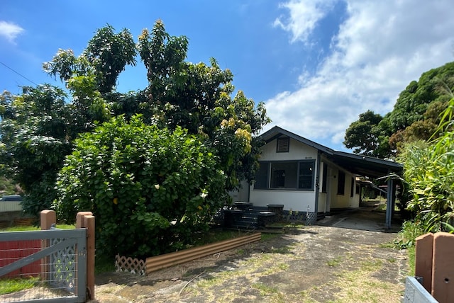 view of side of property with a carport