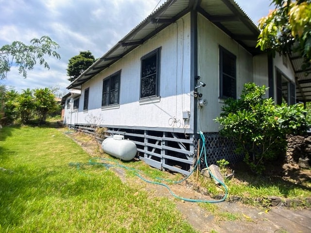 view of home's exterior with a yard