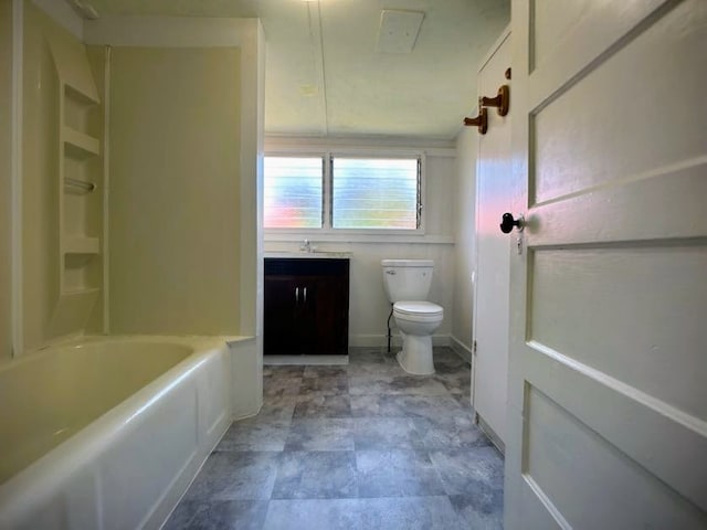 bathroom featuring vanity, a bathtub, and toilet