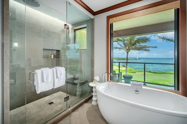 bathroom featuring tile patterned flooring, a water view, separate shower and tub, and ornamental molding