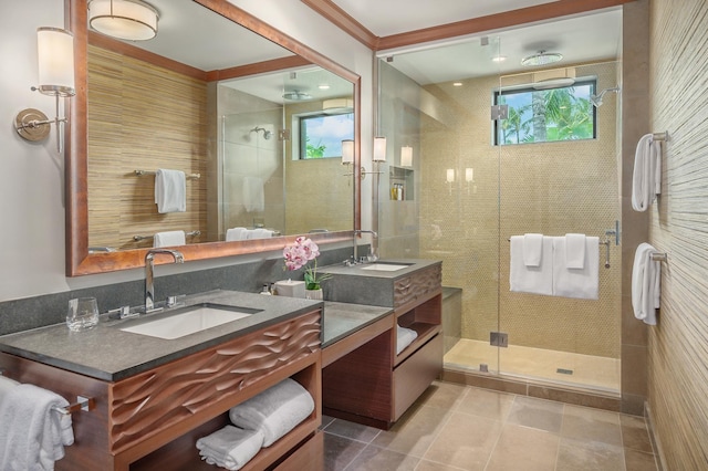 bathroom with tile patterned floors, crown molding, vanity, and an enclosed shower