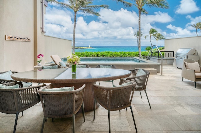 view of patio / terrace featuring grilling area and a water view