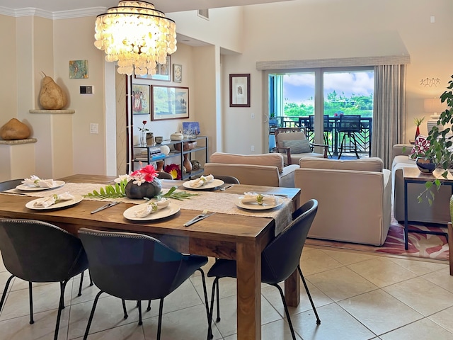 dining space featuring ornamental molding, light tile patterned floors, and a chandelier