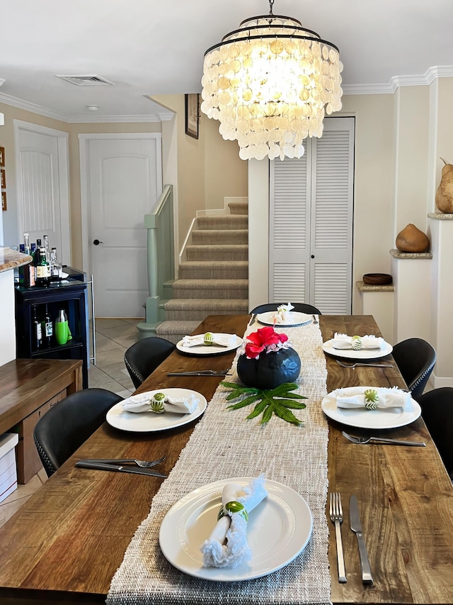 dining area featuring ornamental molding, light tile patterned floors, and a chandelier