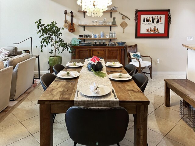 tiled dining space with ornamental molding and a notable chandelier