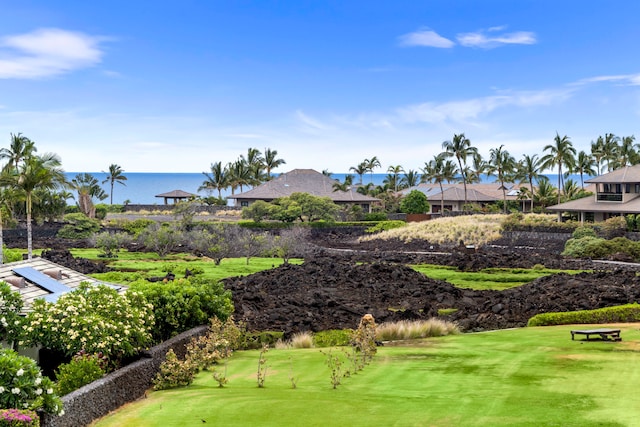 surrounding community featuring a lawn and a water view