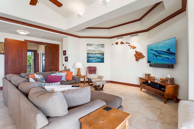 living room with ceiling fan, a raised ceiling, and crown molding