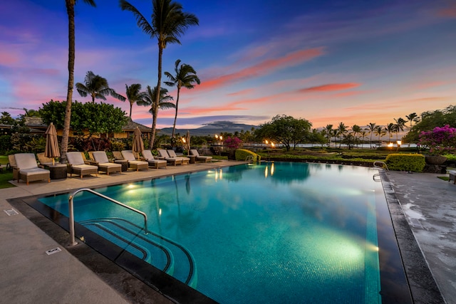 pool at dusk with a patio