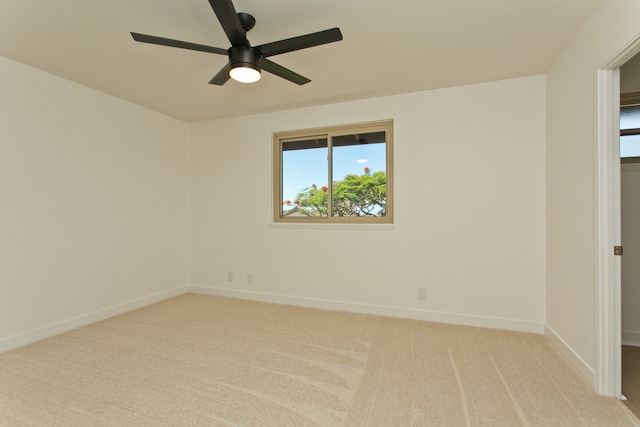 unfurnished room featuring light carpet and ceiling fan