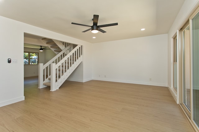 empty room featuring ceiling fan and light wood-type flooring