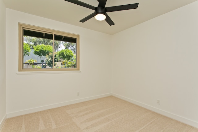 carpeted spare room with ceiling fan