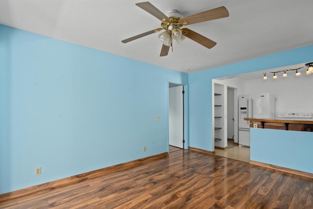 unfurnished living room with hardwood / wood-style flooring and ceiling fan