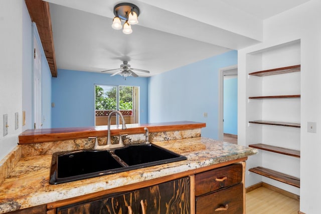 kitchen with ceiling fan, beam ceiling, sink, and light wood-type flooring