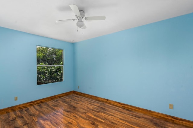 unfurnished room with dark hardwood / wood-style flooring and ceiling fan