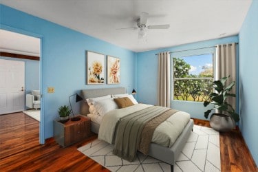 bedroom with ceiling fan and dark hardwood / wood-style flooring