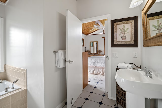 bathroom featuring sink, wooden ceiling, and tiled tub