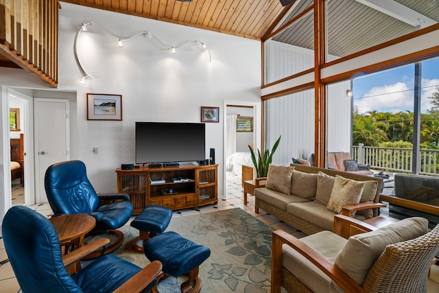 living room with light tile patterned floors, high vaulted ceiling, and wooden ceiling