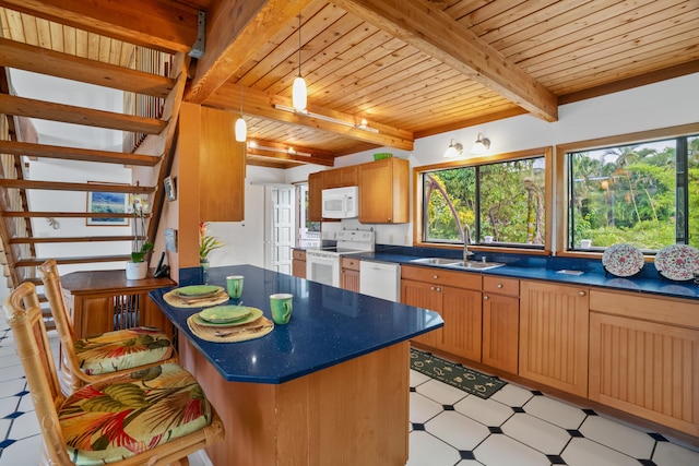 kitchen featuring sink, beamed ceiling, pendant lighting, white appliances, and wood ceiling