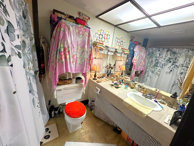 bathroom featuring vanity, toilet, and tile patterned floors