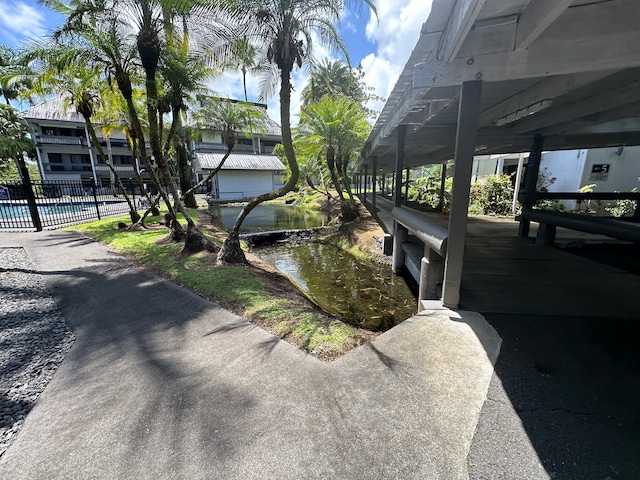 exterior space featuring a water view and a swimming pool