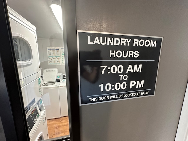 details with stacked washer / dryer and hardwood / wood-style floors