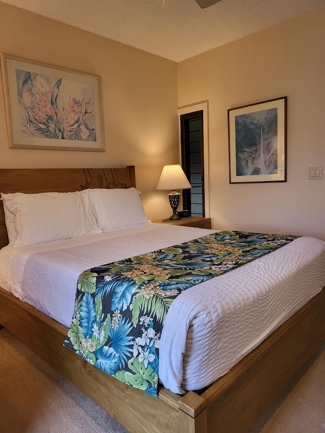 bedroom with carpet and a textured ceiling