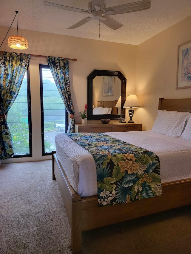 carpeted bedroom with ceiling fan, a textured ceiling, and access to exterior