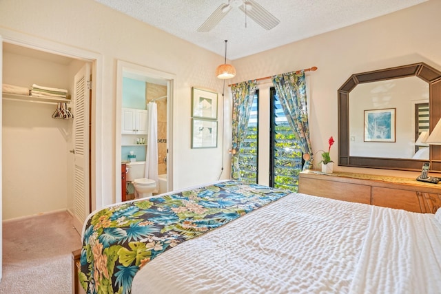 carpeted bedroom with ceiling fan, ensuite bathroom, a closet, and a textured ceiling