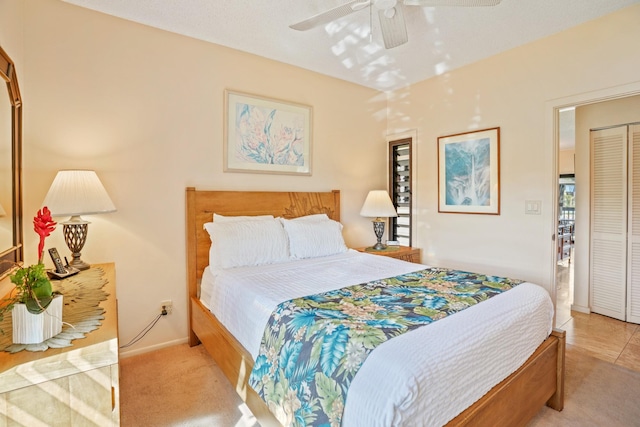 carpeted bedroom with a closet and ceiling fan