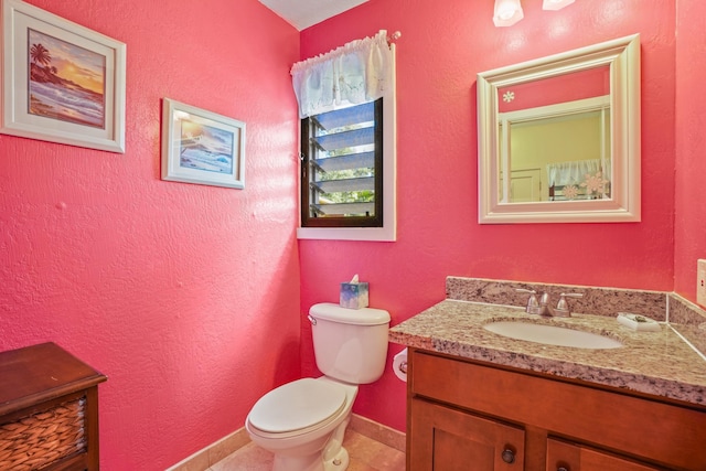 bathroom featuring tile patterned floors, vanity, and toilet