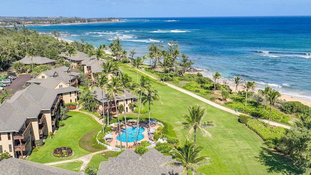 birds eye view of property featuring a water view and a beach view