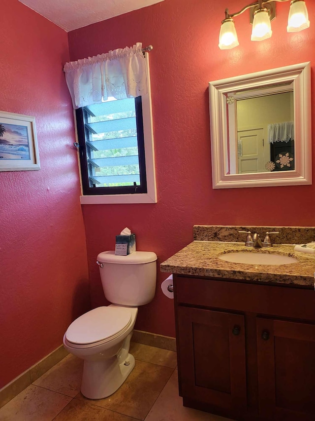 bathroom with vanity, tile patterned floors, and toilet