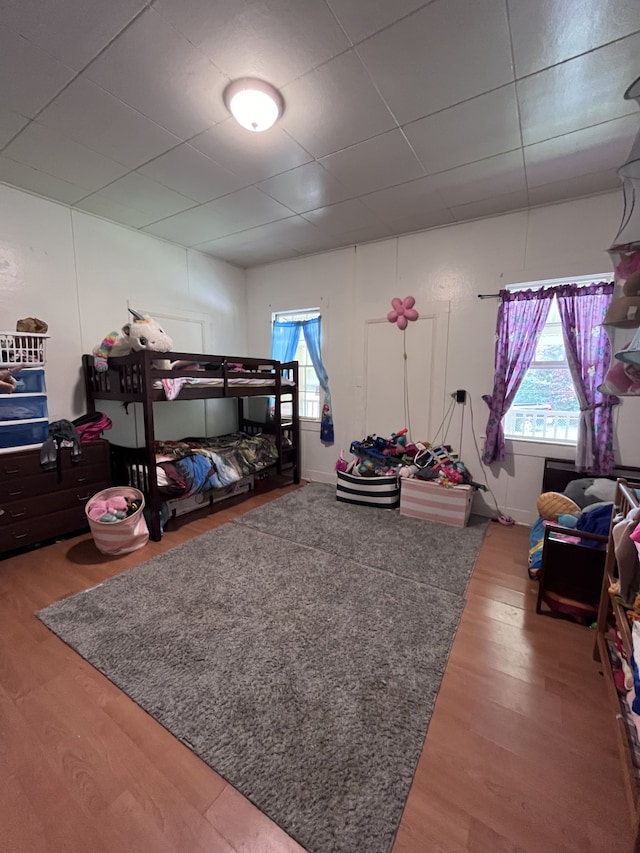 bedroom featuring a paneled ceiling and wood-type flooring