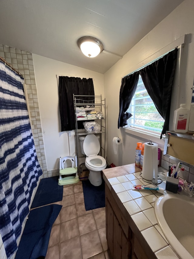 bathroom featuring vanity, a shower with curtain, tile patterned floors, and toilet