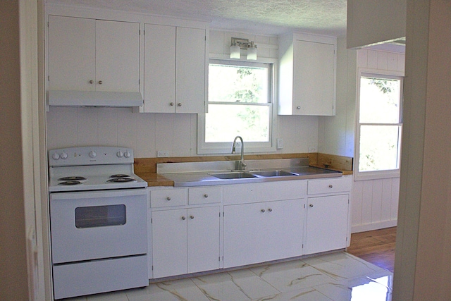 kitchen featuring sink, white cabinets, a textured ceiling, and electric stove